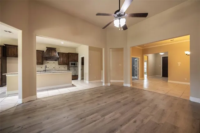 a view of a kitchen with a sink and a refrigerator