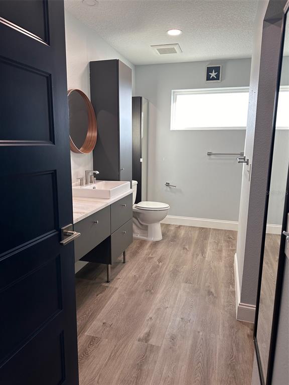 7119 Fair Lane Hudson, FL 34667 - Photo 12 of 32 a bathroom with a toilet a sink and mirror