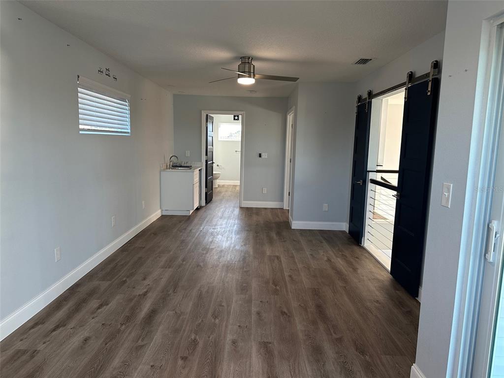 7119 Fair Lane Hudson, FL 34667 - Photo 15 of 32 a view of empty room with wooden floor and window