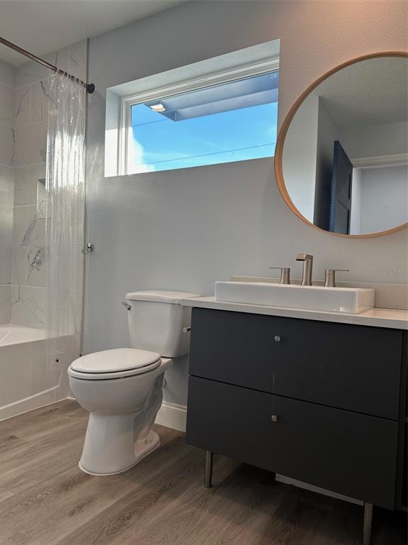 7119 Fair Lane Hudson, FL 34667 - Photo 20 of 32 a bathroom with a toilet sink and mirror