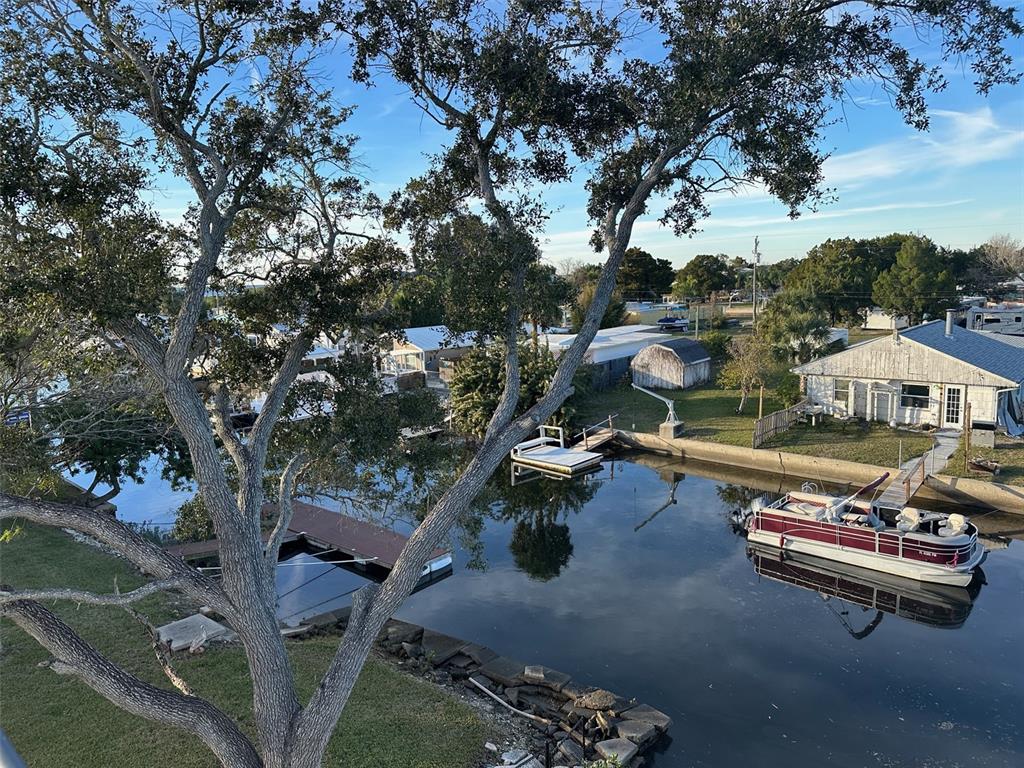 7119 Fair Lane Hudson, FL 34667 - Photo 2 of 32 an aerial view of a swimming pool with outdoor seating