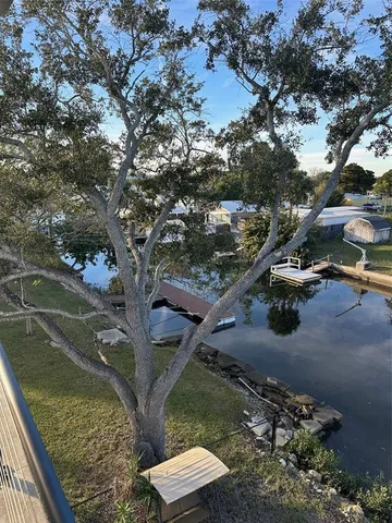 an aerial view of ocean and residential houses with outdoor space
