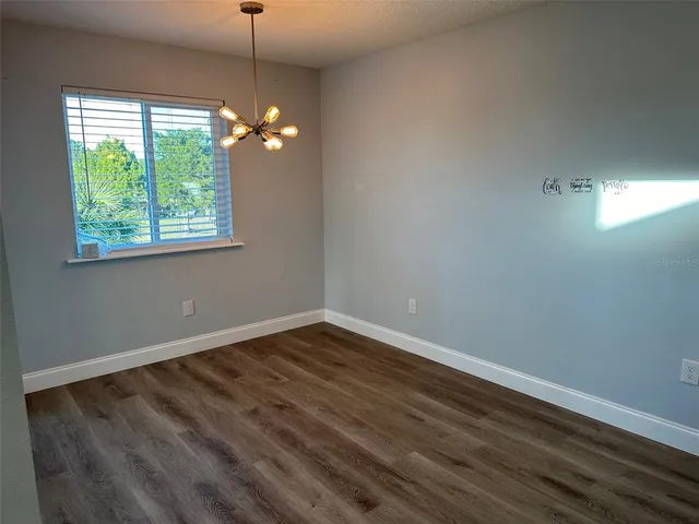 a view of room with hardwood floor and fan