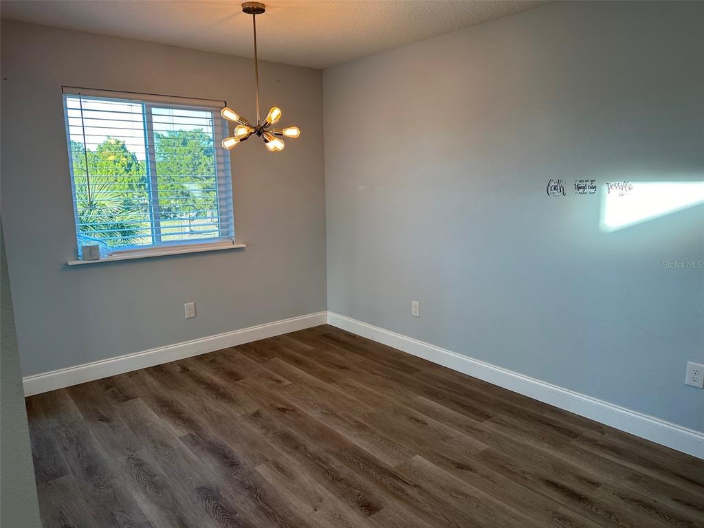 7119 Fair Lane Hudson, FL 34667 - Photo 7 of 32 a view of room with hardwood floor and fan