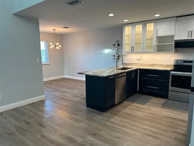 a kitchen with stainless steel appliances granite countertop a sink counter space and cabinets