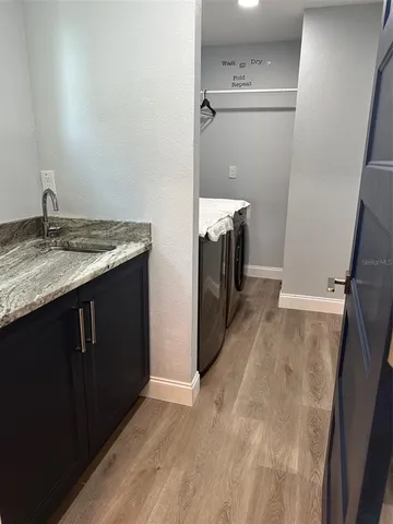 a kitchen with a sink and a mirror