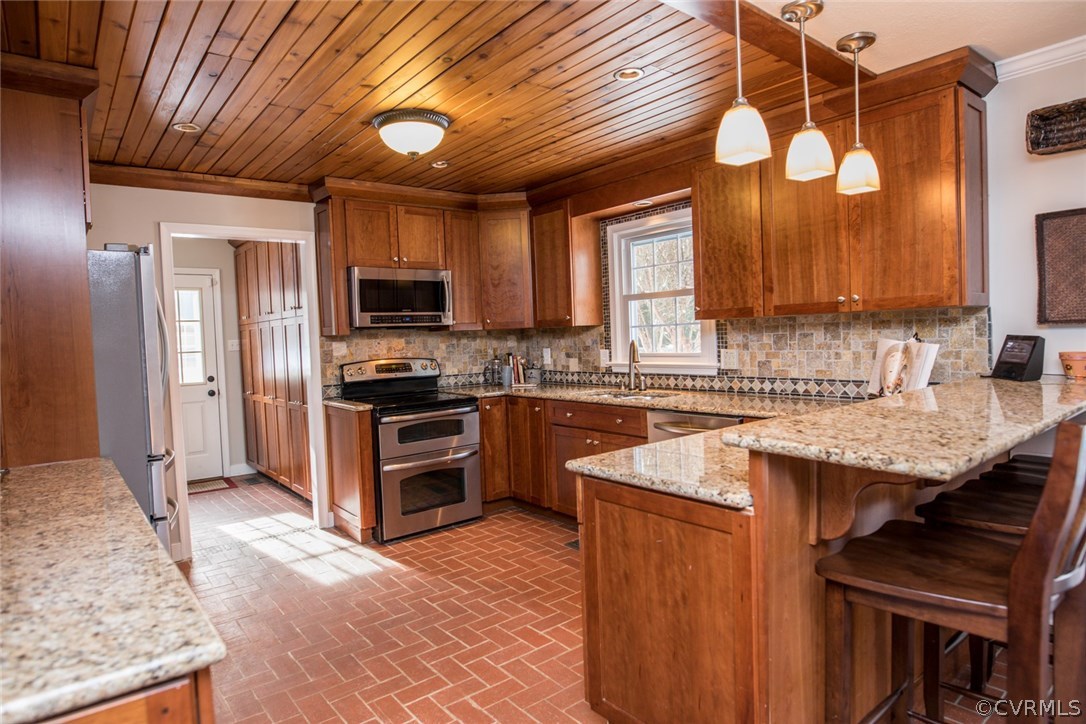 12100 Bundle Road Chesterfield, VA 23838 - Photo 8 of 50 a kitchen with granite countertop a stove top oven a sink dishwasher a dining table and chairs with wooden floor