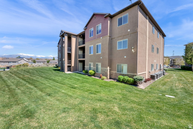 8215 Clear Rock Road, Unit 12 Eagle Mountain, UT 84005 - Photo 34 of 38 Multi-story building featuring stucco and horizontal siding, multiple balconies, and ground-level shrubbery