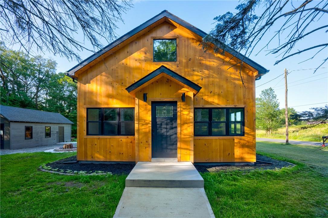 a front view of house with yard and green space