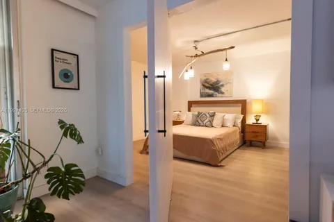 a bedroom with a bed and a potted plant