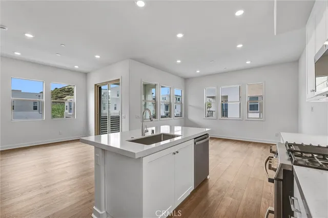 a kitchen with white cabinets stainless steel appliances and sink