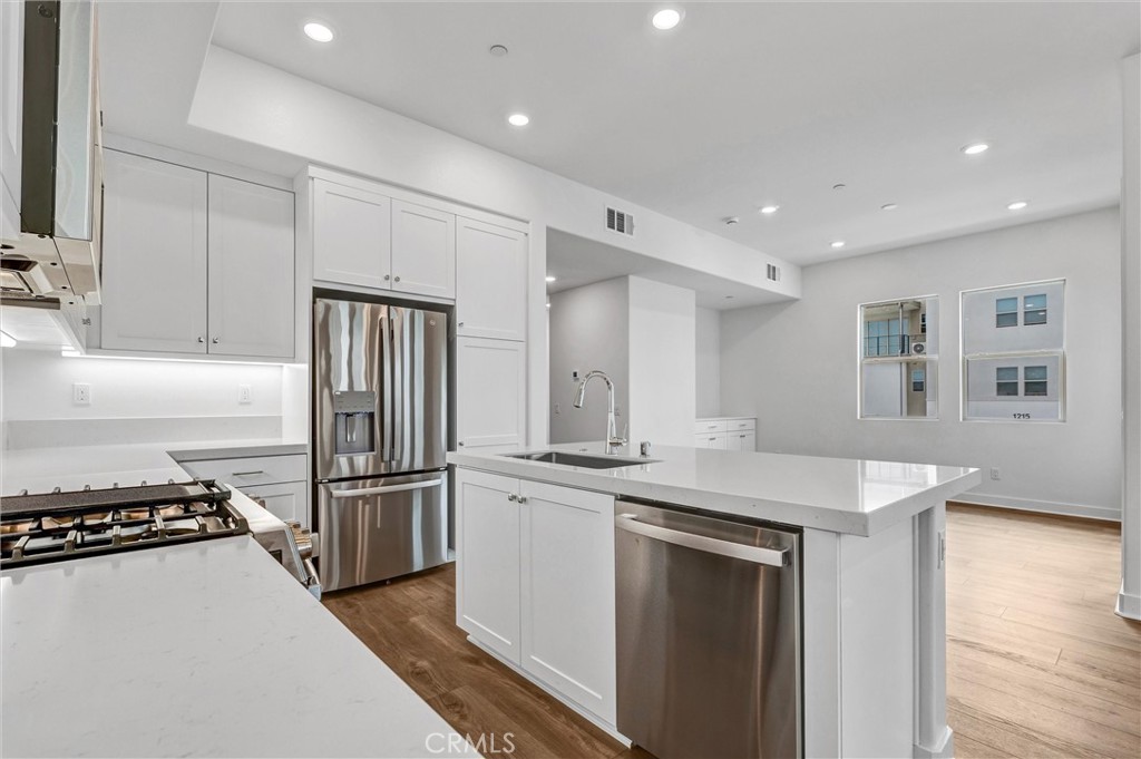1808 Hollyleaf Terrace Montebello, CA 90640 - Photo 16 of 56 a kitchen with stainless steel appliances granite countertop a refrigerator and a stove