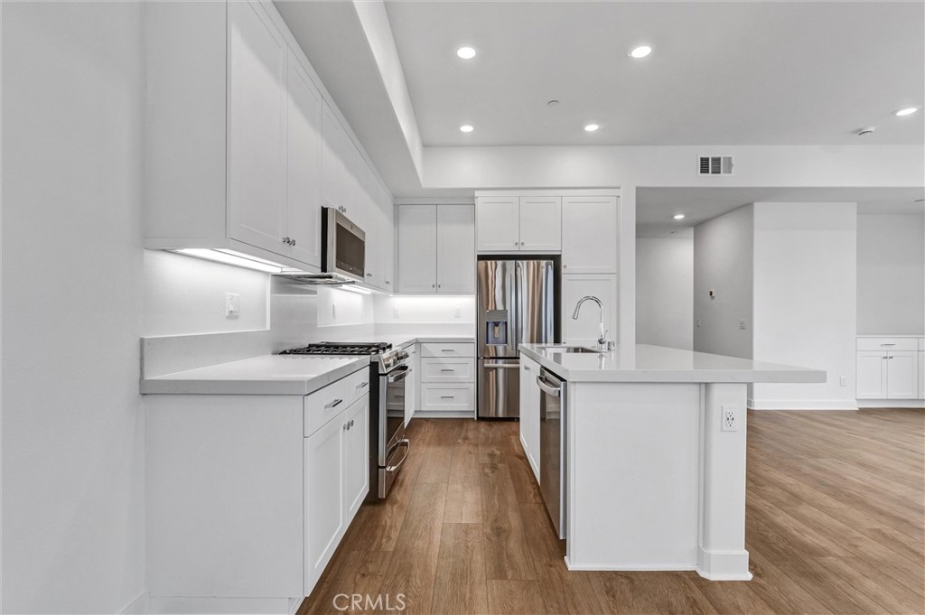 1808 Hollyleaf Terrace Montebello, CA 90640 - Photo 17 of 56 a kitchen with stainless steel appliances a refrigerator and a stove top oven