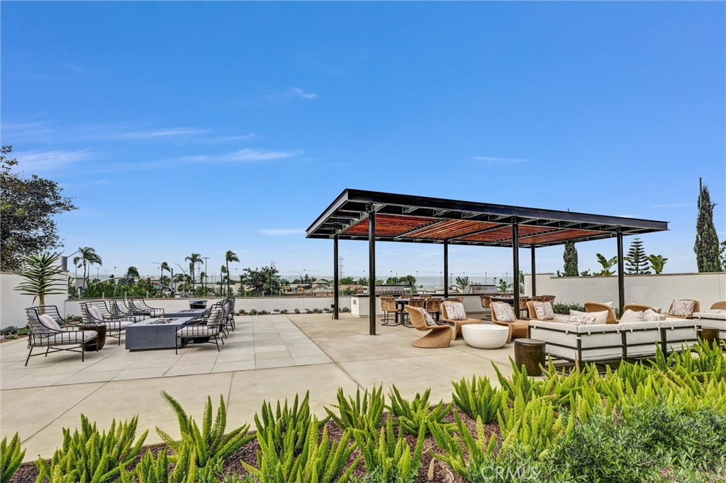 1808 Hollyleaf Terrace Montebello, CA 90640 - Photo 39 of 56 a view of a patio with table and chairs under an umbrella with palm trees