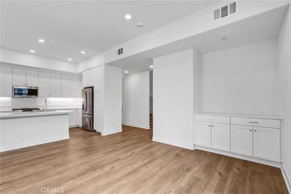 a view of kitchen with stainless steel appliances refrigerator microwave and stove