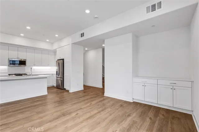 a view of kitchen with stainless steel appliances refrigerator microwave and stove