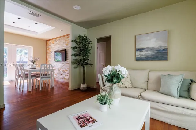 a living room with furniture potted plant and a table