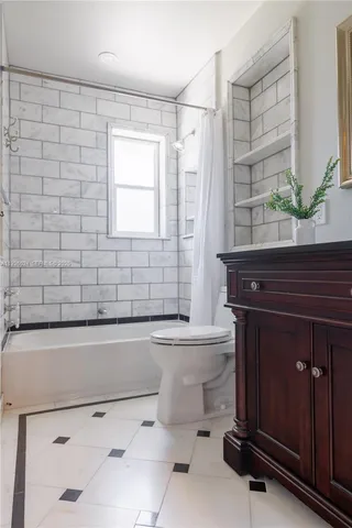 a bathroom with a sink a toilet and bathtub