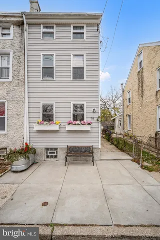 a view of a brick house with many windows