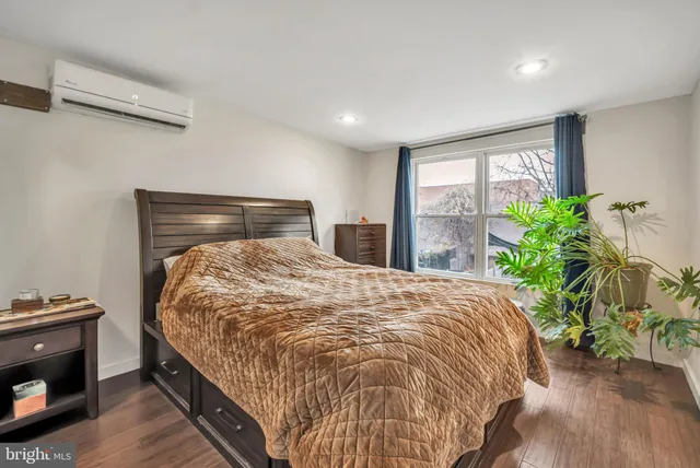 a bed sitting in a bedroom next to a window
