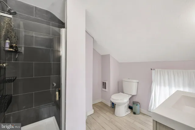 a bathroom with a toilet and a shower