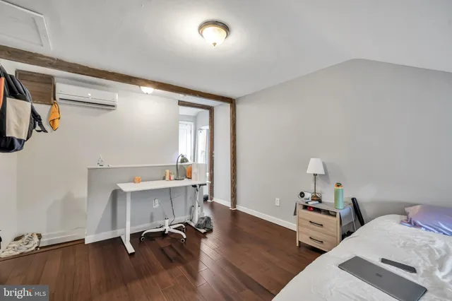a view of a workspace with furniture and wooden floor