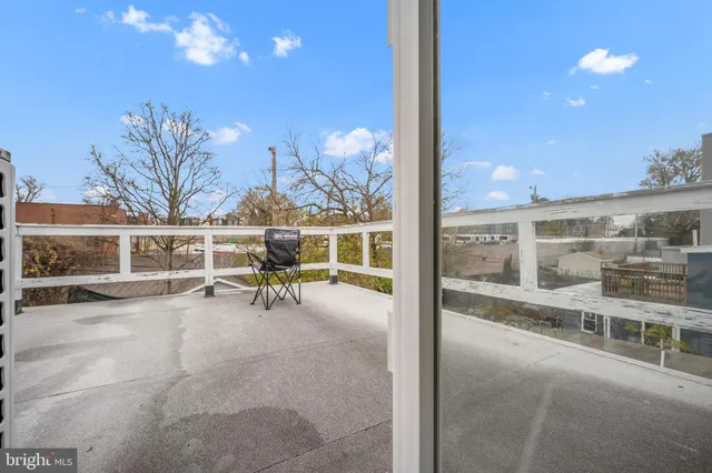 a view of a porch with chairs and tables