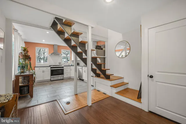 a view of entryway and hall with wooden floor