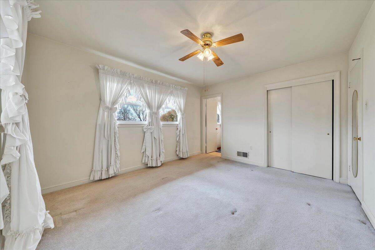 449 Cameron Drive Vinton, VA 24179 - Photo 18 of 39 an empty room with windows and chandelier fan