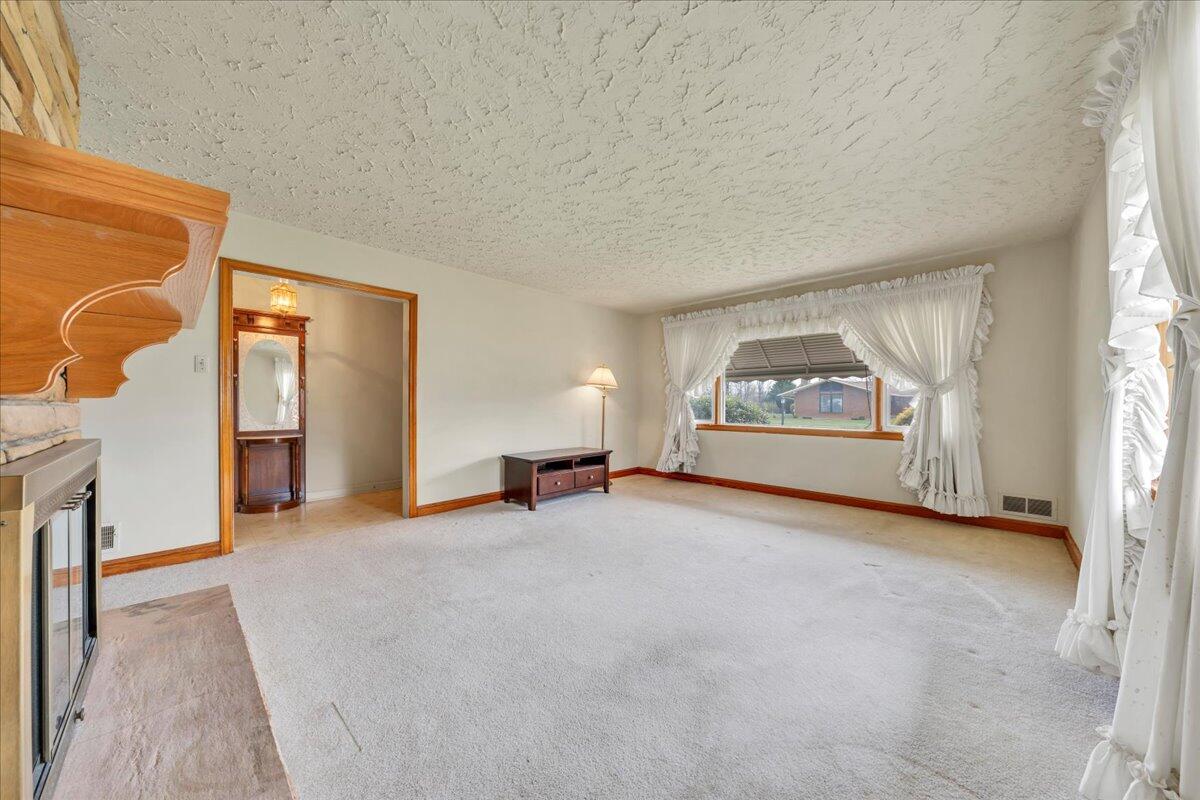 449 Cameron Drive Vinton, VA 24179 - Photo 9 of 39 an empty room with furniture and a fireplace