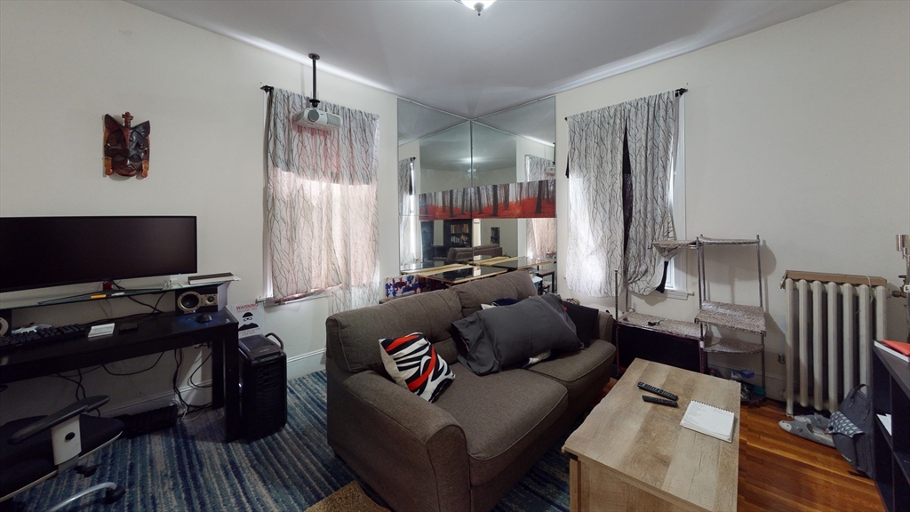 22 Chiswick Road, Unit 15 Boston, MA 02135 - Photo 2 of 5 a living room with furniture and a flat screen tv