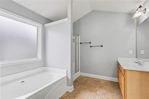 a bathroom with a tub sink and vanity