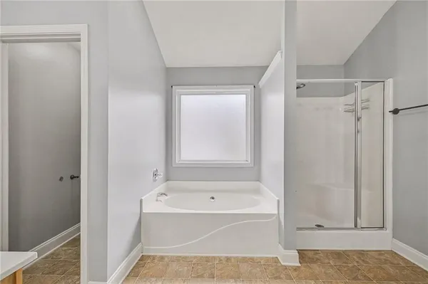 a bathroom with a bathtub and a shower