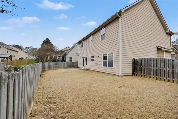 a view of a house with a fence