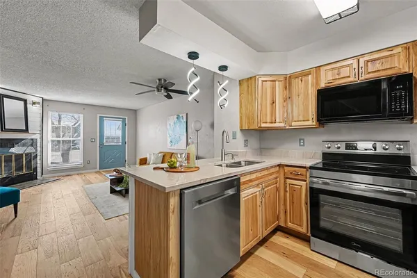 a kitchen with stainless steel appliances a stove sink microwave and cabinets