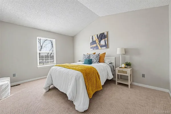 a bed room with a bed and a window
