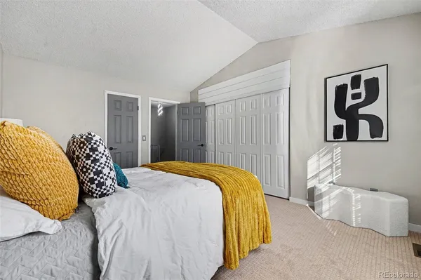 a bedroom with a bed and a couch