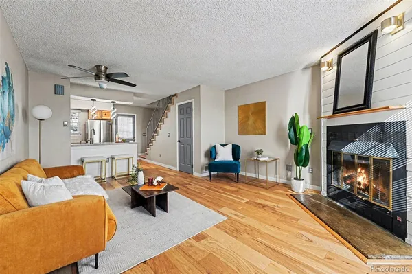 a living room with furniture and a fireplace