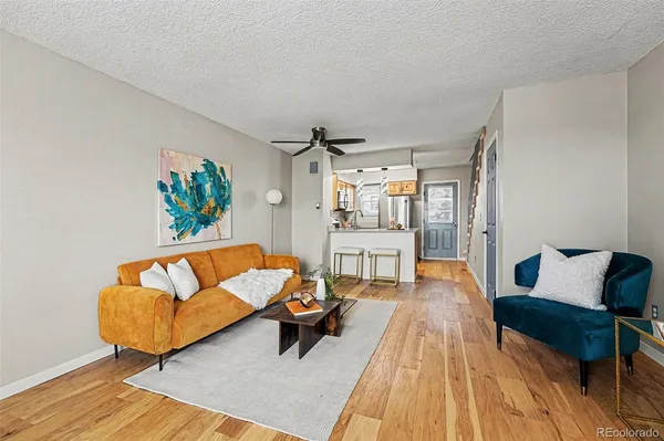 a living room with furniture and a wooden floor