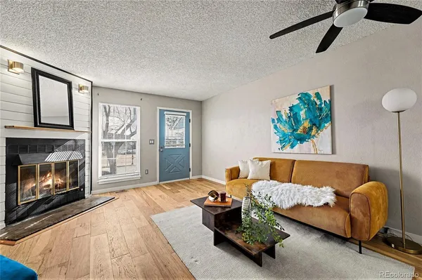a living room with furniture and a fireplace