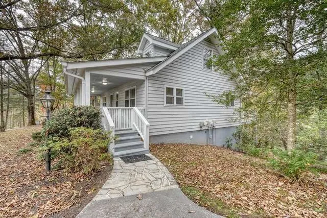 a view of empty room with wooden floor and fireplace