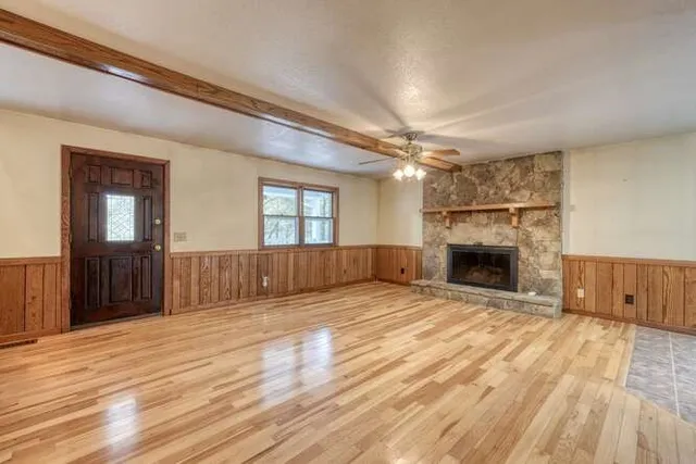 a kitchen with granite countertop a stove a sink and a refrigerator