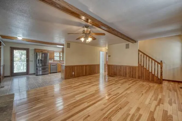 a kitchen with stainless steel appliances granite countertop a refrigerator and a sink
