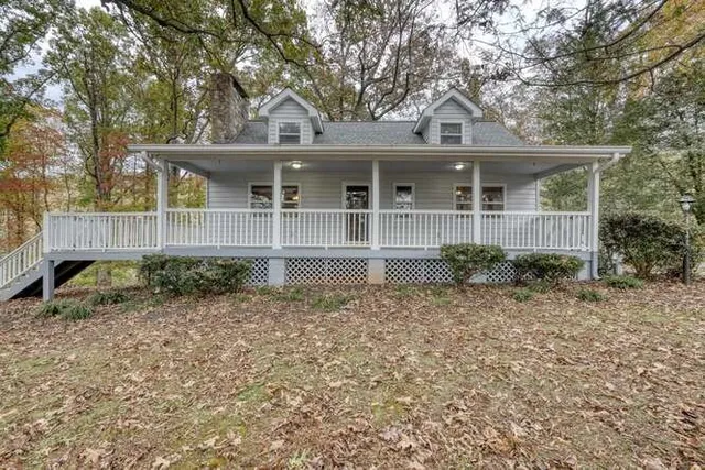 a view of a livingroom with wooden floor and a fireplace