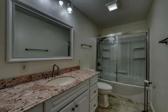 an empty room with fan and windows