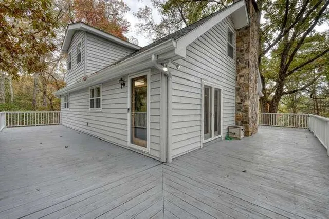 a view of a livingroom with wooden floor and a large window