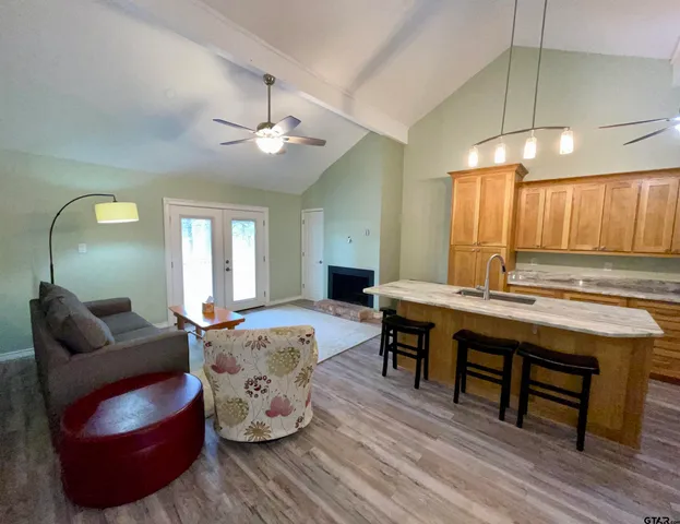 a living room with furniture and wooden floor