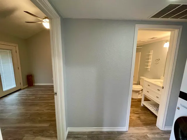 a view of walk in closet with wooden floor