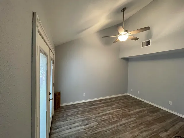 wooden floor in an empty room with a window