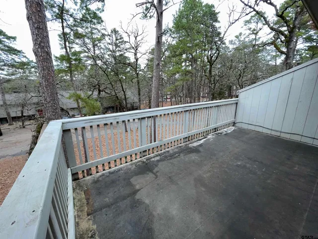 a view of a balcony with wooden fence